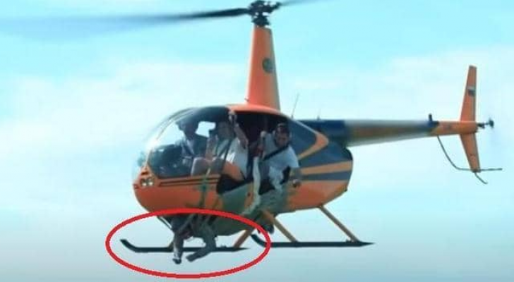 الشخص الملتصق بالمروحية داخل الدائرة الحمراء