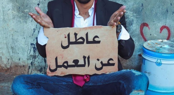 شخص يحمل يافطة "عاطل عن العمل"
