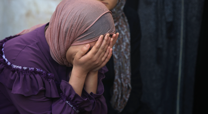 فلسطينية تبكي بعد إلقاء نظرة الوداع لأحد أقاربها الذي استشهد بعدوان الاحتلال على غزة
