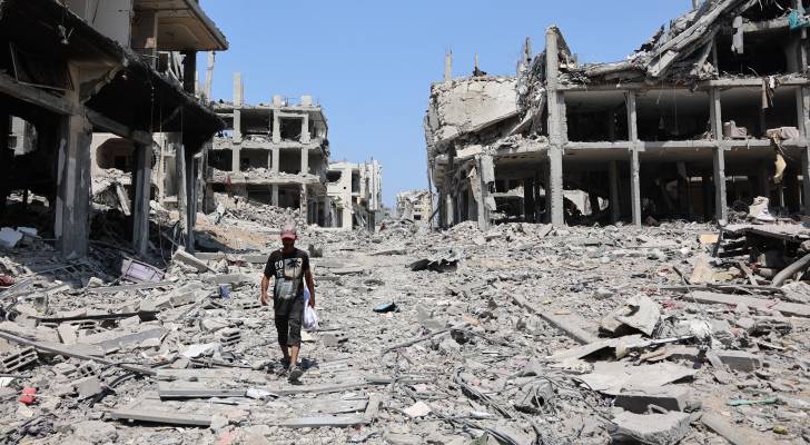 رجل فلسطيني يمر بجانب مبان مدمرة في حي التفاح بمدينة غزة