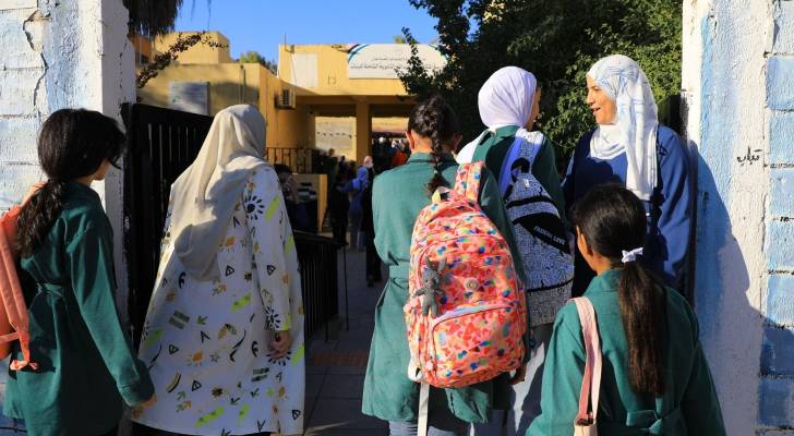 طالبة مدارس أمام مدرستهم
