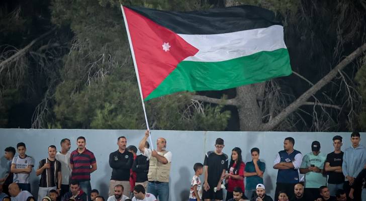 مشجع يرفع العلم الأردني في ستاد عمان الدولي
