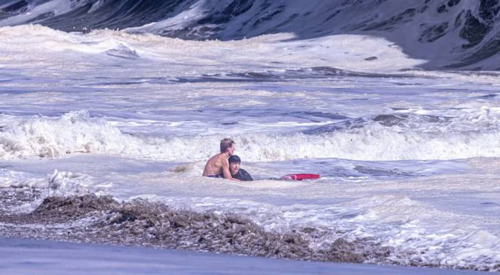 Rookie teenager lifeguard rescues boy from rough surf