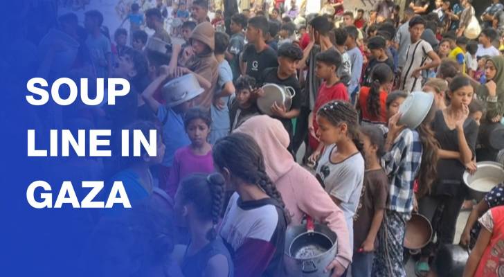 Gazan children queue at charity kitchen point to receive lentil soup
