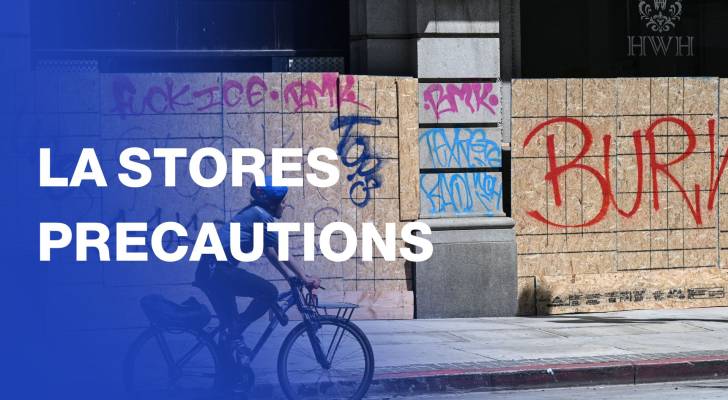 Workers board up storefronts in downtown Los Angeles