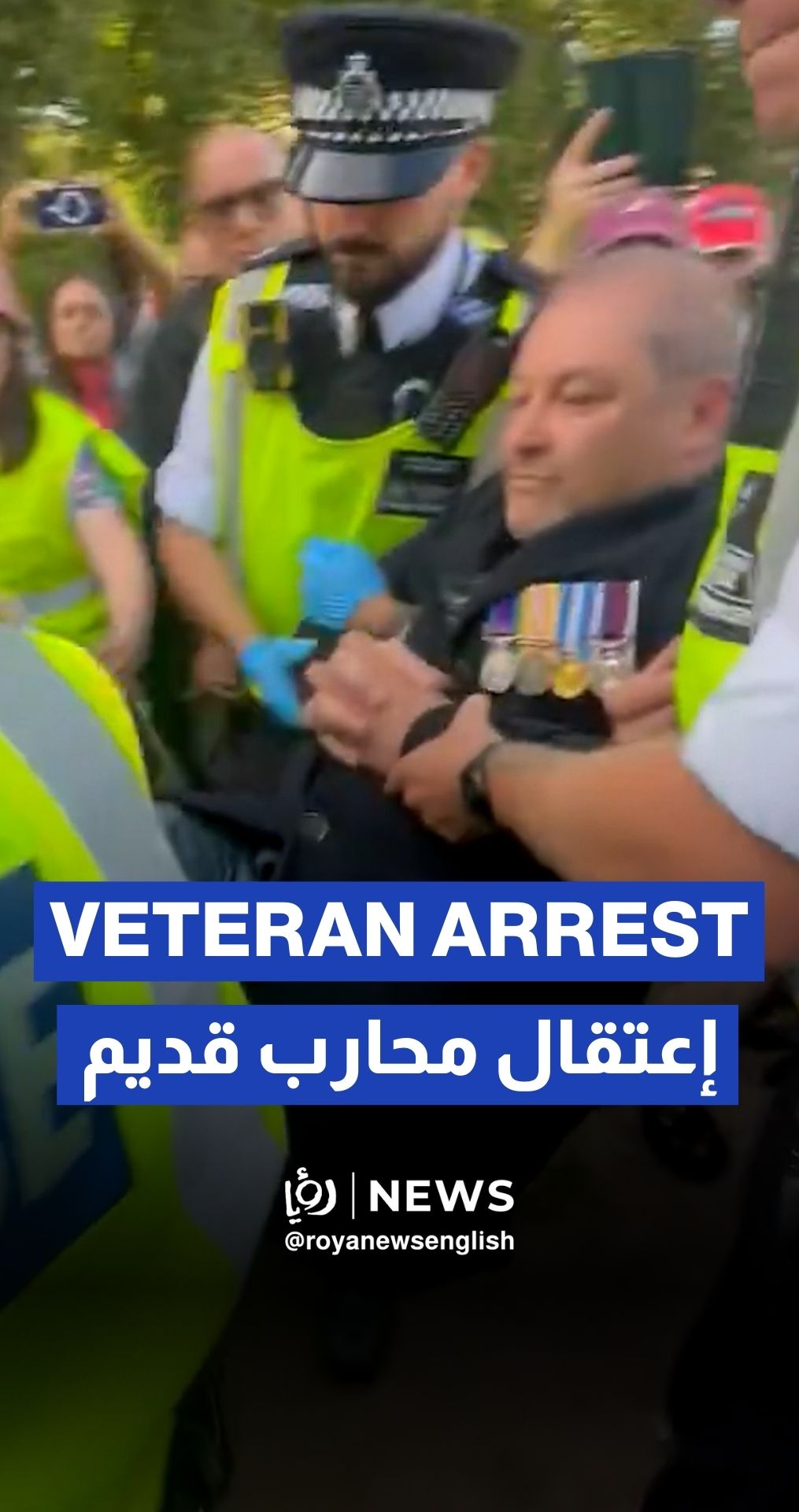 London police arrest a veteran for holding up a paper sign in support of Palestine Action