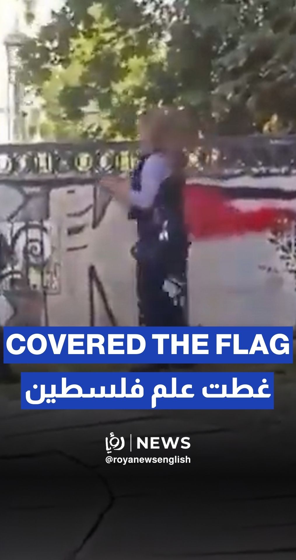 German policewoman trying to cover the Palestinian flag by spraying red paint