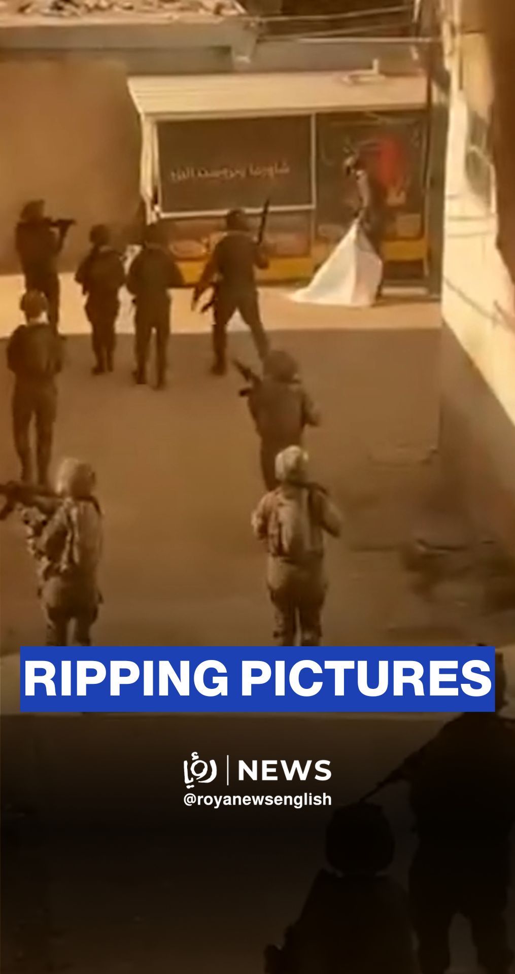 'Israeli' soldiers tear photos of martyrs during raid south of Tubas