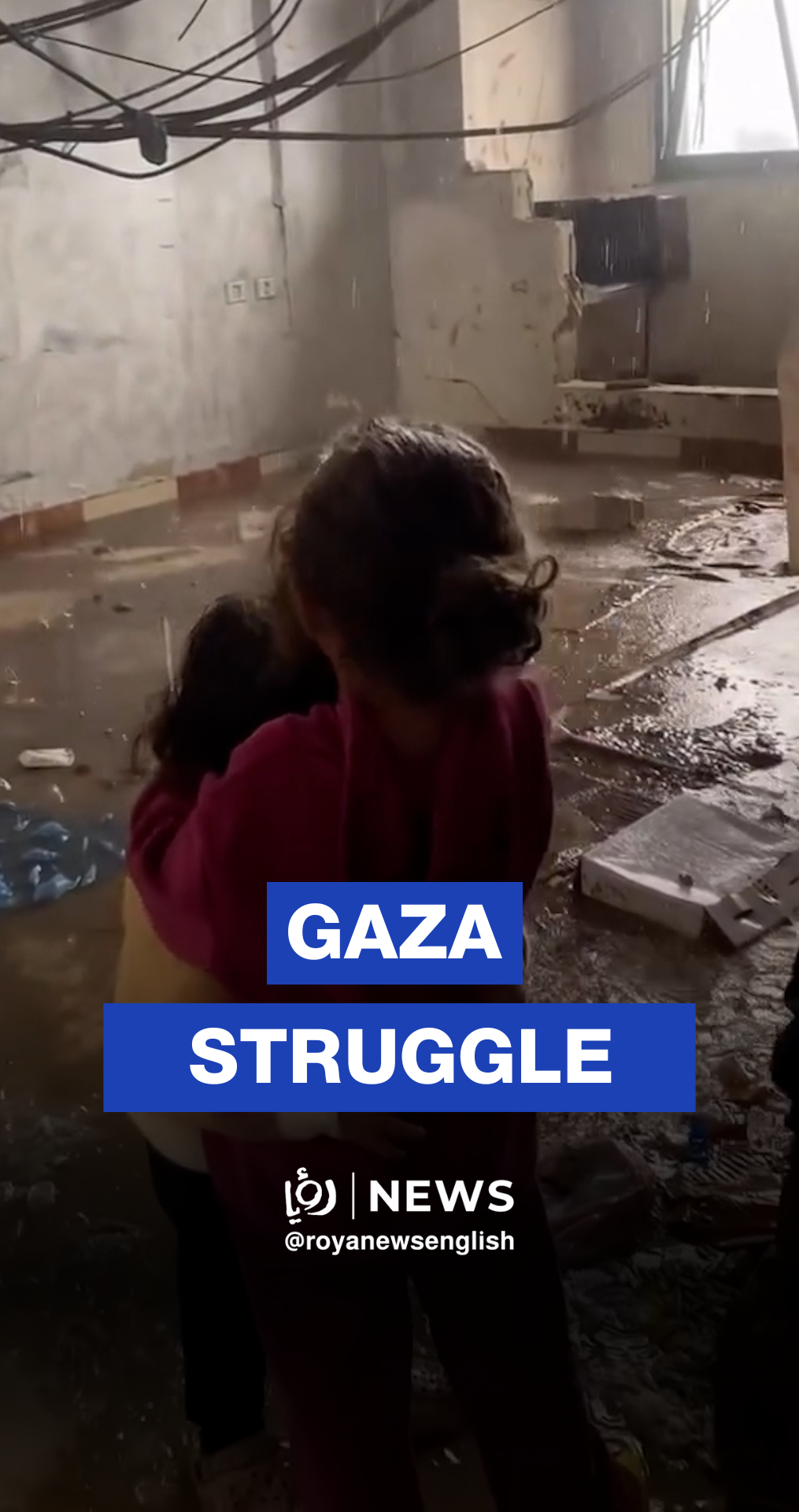 Gaza girl comforts her sister as rain floods their home