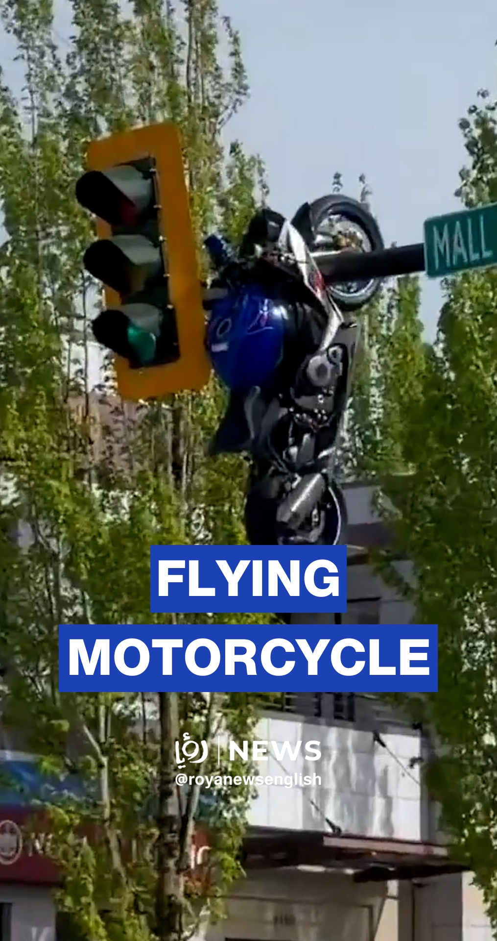 Motorcycle hanging off traffic light after crash